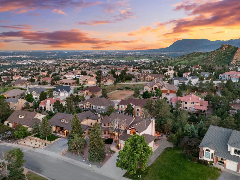 an aerial view of a neighborhood in colorado with mountains in the background an aerial view of a neighborhood in colorado with mountains in the background